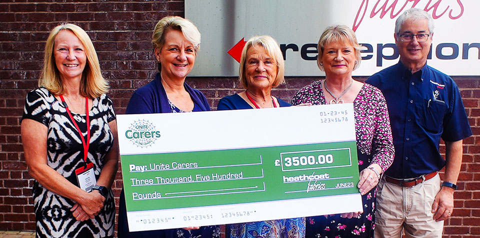 presenting cheque for £3,500 to Unite carers