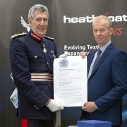 The Lord-Lieuteant of Devon and Heathcoat MD Cameron Harvie displaying the official scroll