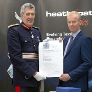 The Lord-Lieuteant of Devon and Heathcoat MD Cameron Harvie displaying the official scroll